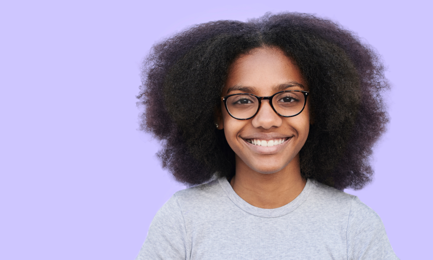 A smiling child wearing glasses